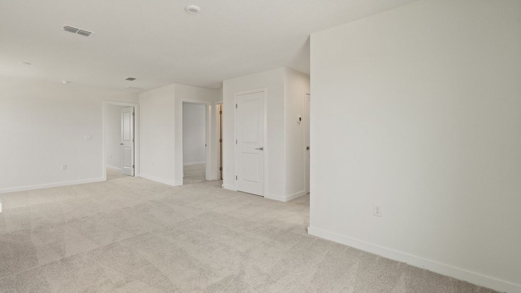 Versatile upstairs loft perfect for a media room, home gym, playroom, or secondary living area