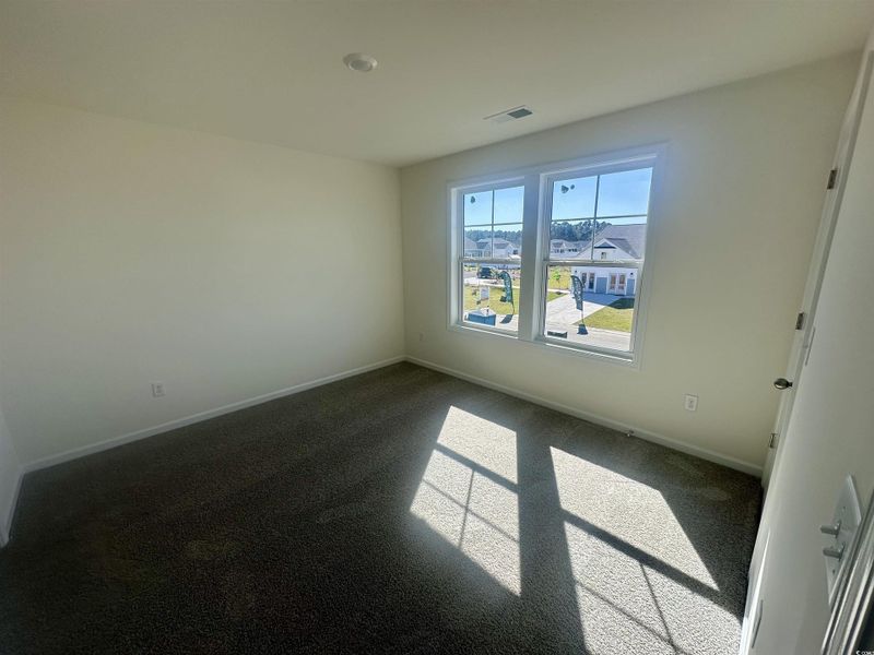 Carpeted empty room featuring baseboards Carpeted empty room featuring baseboards