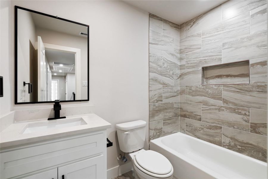 A beautifully finished bathroom continues the home’s modern style with sleek fixtures and eye-catching tilework. It’s a fresh, functional space designed for everyday ease and comfort.