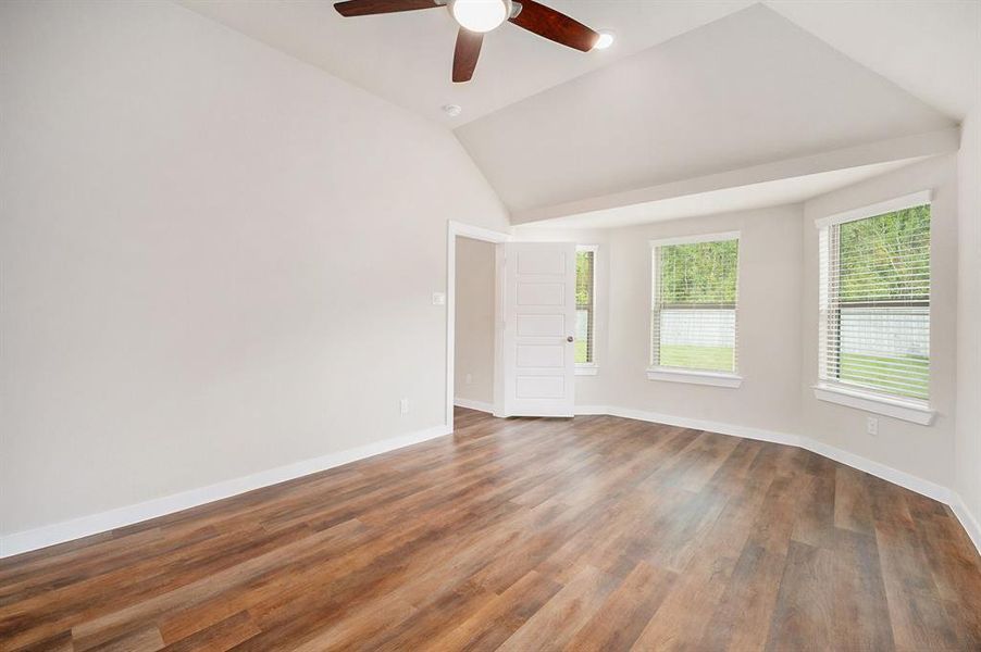 The master bedroom is located in the back of the home with bay windows towards the back yard and high ceiling.