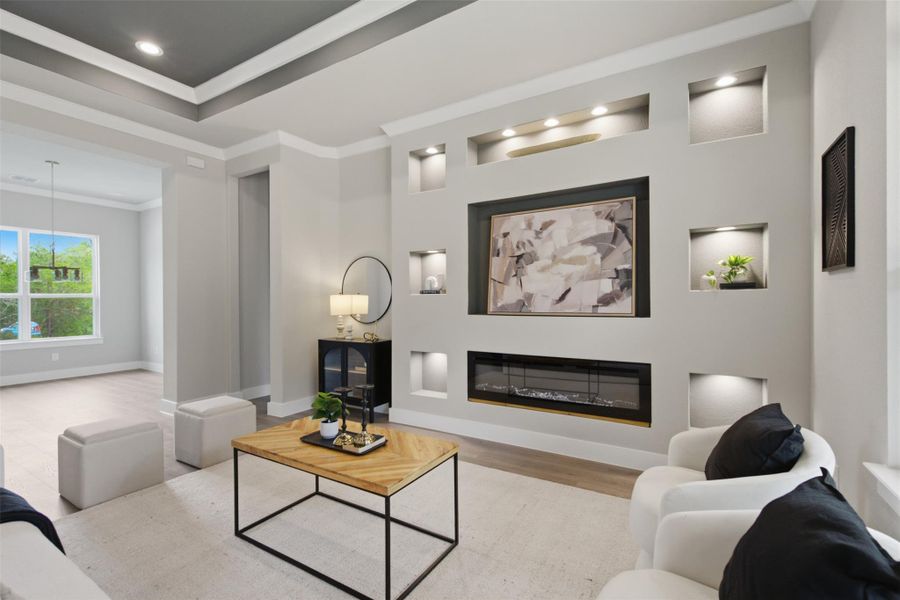 An inviting living room, featuring an integrated electric fireplace and unique recessed display niches. An inviting living room, featuring an integrated electric fireplace and unique recessed display niches.