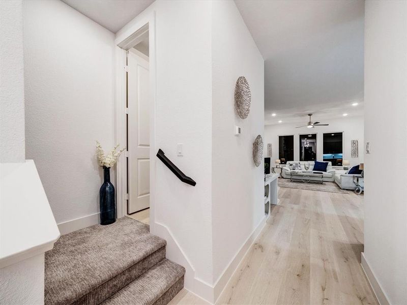 Hall with light wood finished floors and recessed lighting Hall with light wood finished floors and recessed lighting