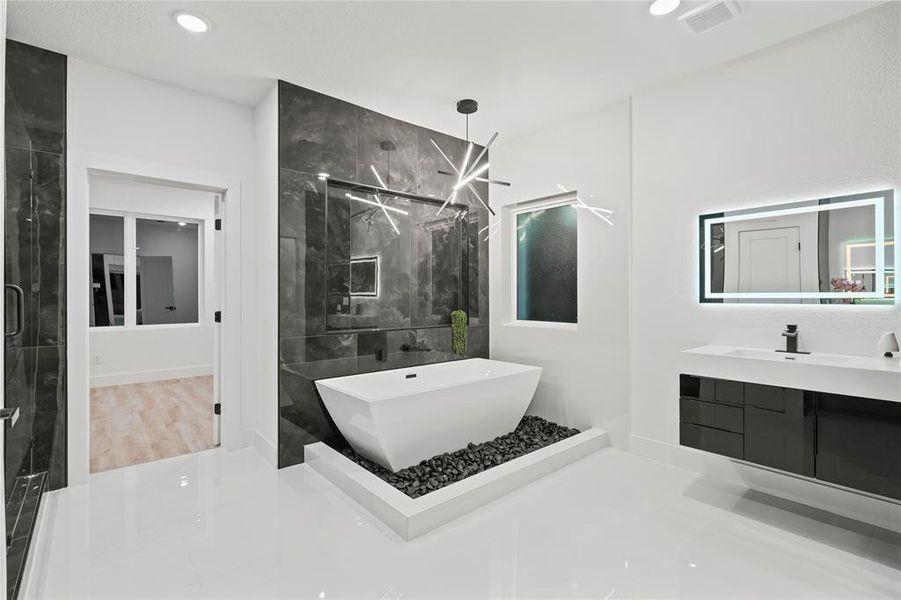 Full bath with a marble finish shower, a freestanding bath, recessed lighting, and vanity Full bath with a marble finish shower, a freestanding bath, recessed lighting, and vanity