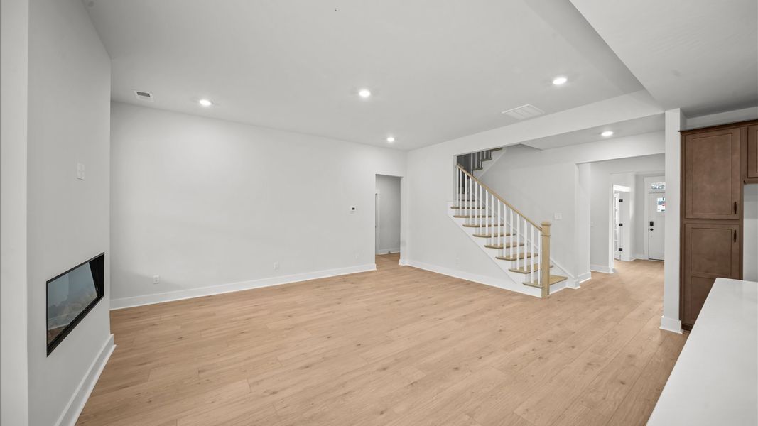 Hardwood flooring and high standards define this vibrant family room ideal for everyday living