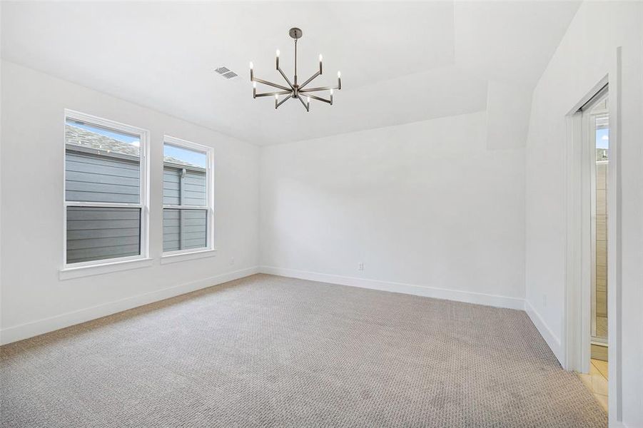 Unfurnished room with visible vents, a notable chandelier, light carpet, and baseboards