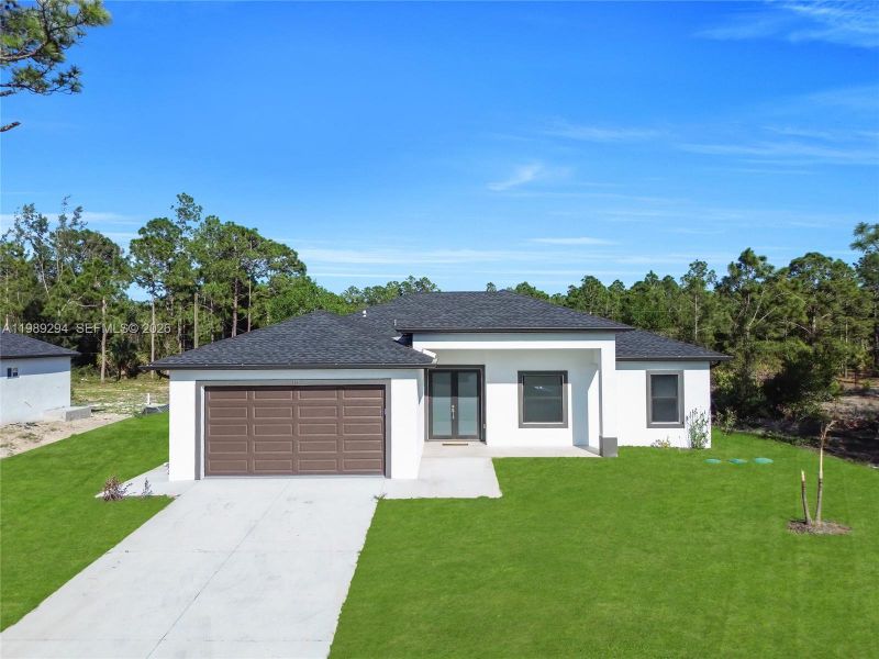 Front exterior of a new home in , Lehigh Acres, FL, highlighting curb appeal (Image 24).
