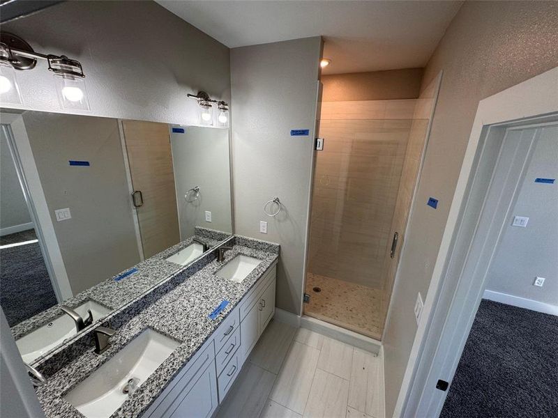 Bathroom featuring vanity, tile patterned floors, and an enclosed shower