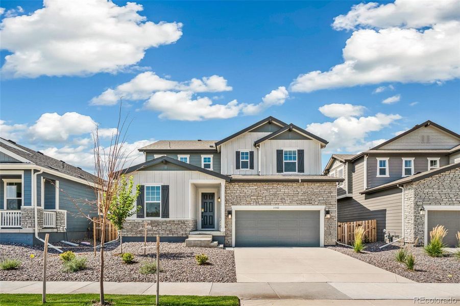 Front exterior of a new home in Turnberry, Commerce City, CO, highlighting curb appeal (Image 19).