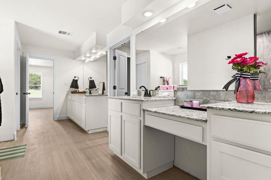 Full bath featuring two vanities, light wood-style floors, and recessed lighting