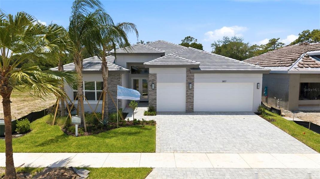 Front exterior of a new home in Valencia Ridge (55+), Wesley Chapel, FL, highlighting curb appeal (Image 2). Front exterior of a new home in Valencia Ridge (55+), Wesley Chapel, FL, highlighting curb appeal (Image 2).