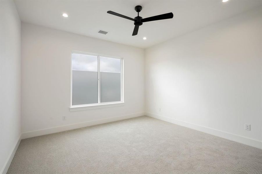 Carpeted bedroom featuring recessed lighting and a ceiling fan Carpeted bedroom featuring recessed lighting and a ceiling fan