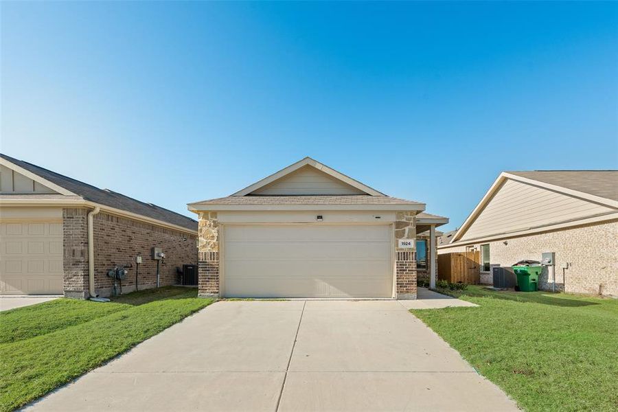 View of front of home featuring brick siding and concrete driveway View of front of home featuring brick siding and concrete driveway