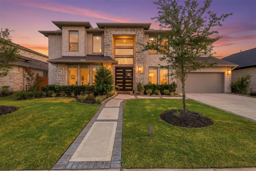 Front exterior of a new home in Elyson, Katy, TX, highlighting curb appeal (Image 22). Front exterior of a new home in Elyson, Katy, TX, highlighting curb appeal (Image 22).