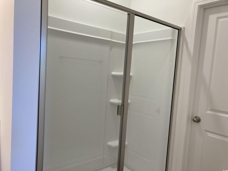 Full bathroom featuring a shower stall