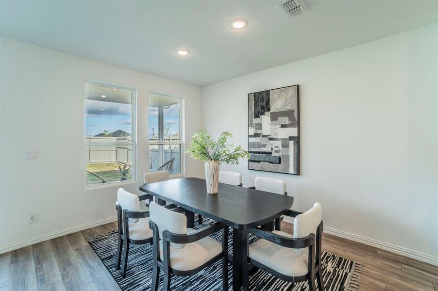 Dining room featuring wood finished floors and recessed lighting Dining room featuring wood finished floors and recessed lighting