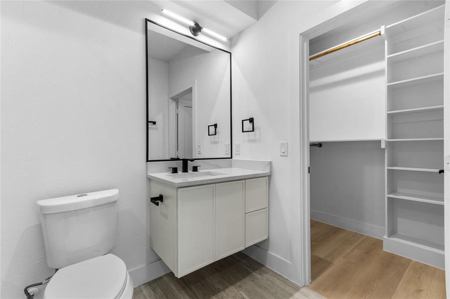 Bathroom featuring a floating vanity with a white countertop and matte black fixtures Bathroom featuring a floating vanity with a white countertop and matte black fixtures