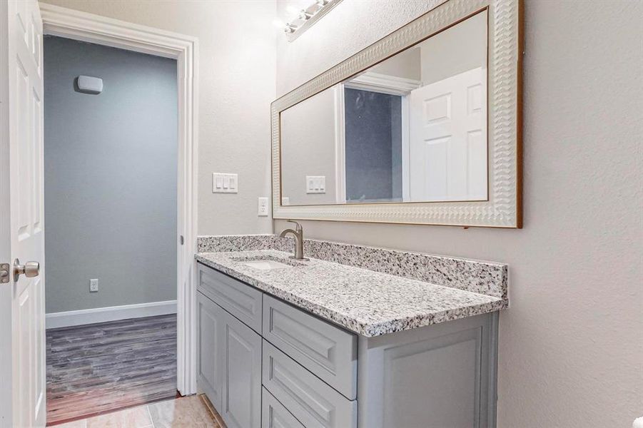 Bathroom featuring hardwood / wood-style flooring and vanity