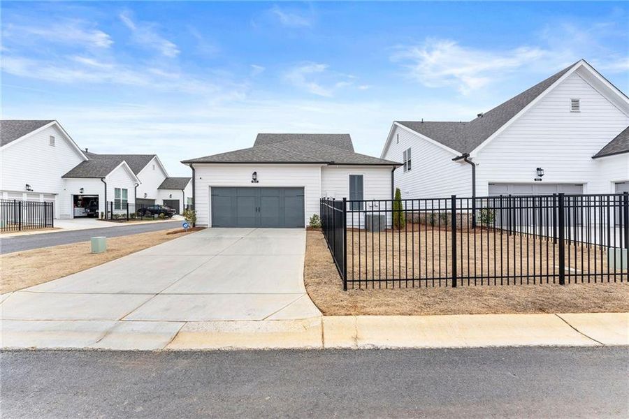 Front exterior of a new home in Promenade at Sawnee Village, Cumming, GA, highlighting curb appeal (Image 27).
