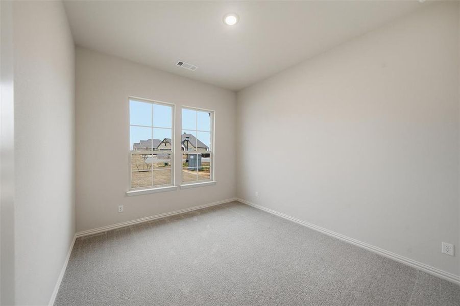 Carpeted empty room with baseboards Carpeted empty room with baseboards