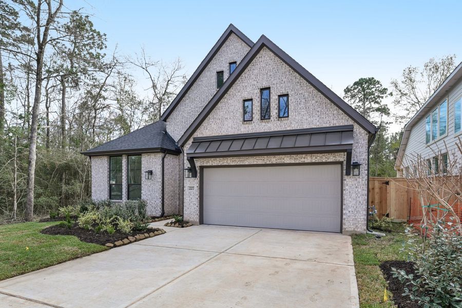 Front exterior of a new home in Wood Leaf Reserve, Tomball, TX, highlighting curb appeal (Image 25).