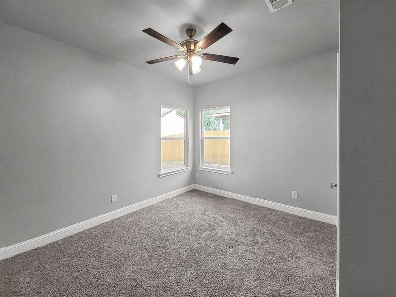 Spare room with carpet flooring, ceiling fan, and baseboards Spare room with carpet flooring, ceiling fan, and baseboards