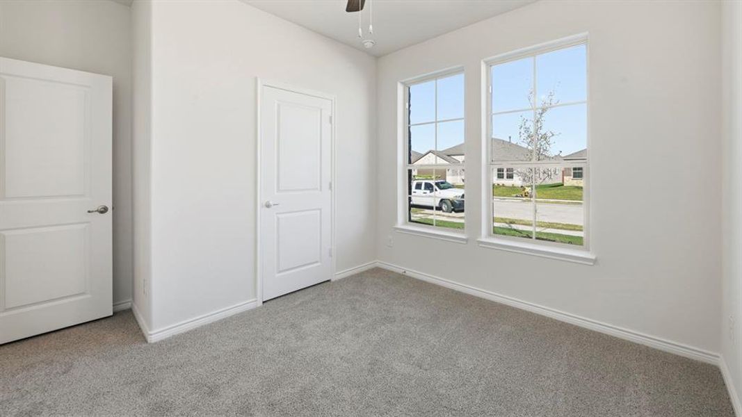 Unfurnished bedroom with carpet floors and a ceiling fan