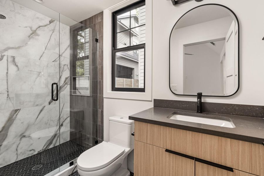 Bathroom with vanity and a marble finish shower Bathroom with vanity and a marble finish shower