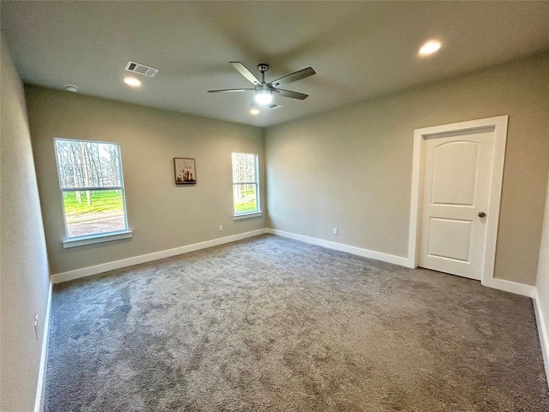 Primary bedroom with recessed lighting.