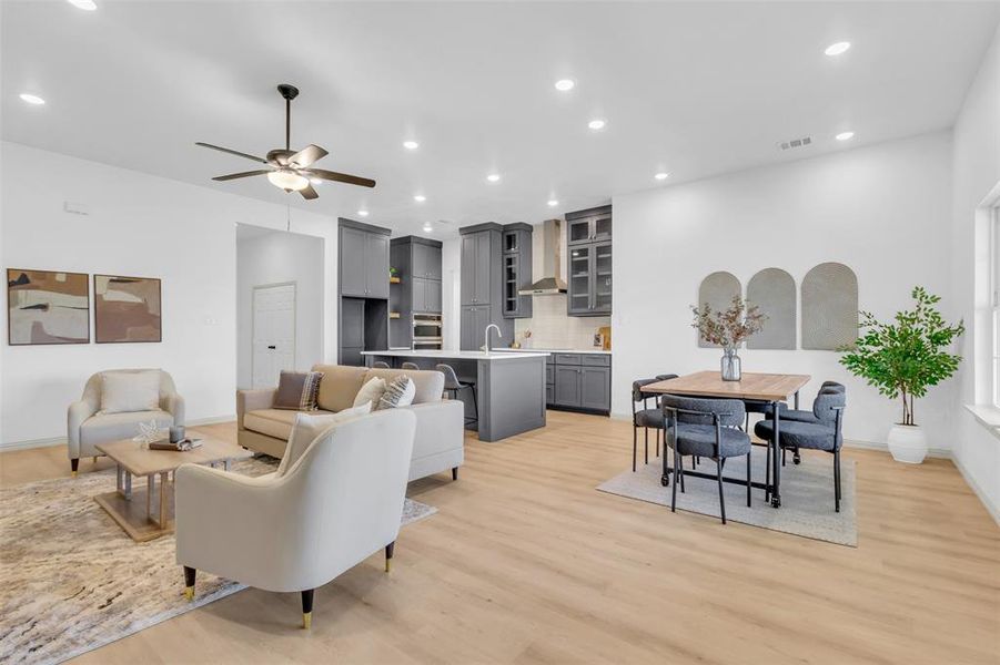 Living room featuring recessed lighting, light wood finished floors, and a ceiling fan Living room featuring recessed lighting, light wood finished floors, and a ceiling fan