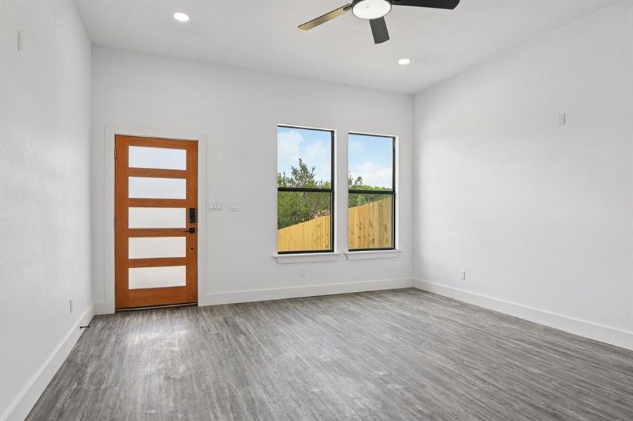 Unfurnished room with wood finished floors, ceiling fan, and recessed lighting Unfurnished room with wood finished floors, ceiling fan, and recessed lighting