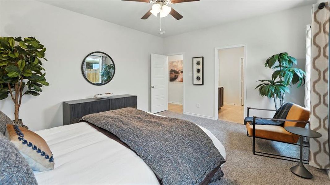 Bedroom featuring light colored carpet and a ceiling fan