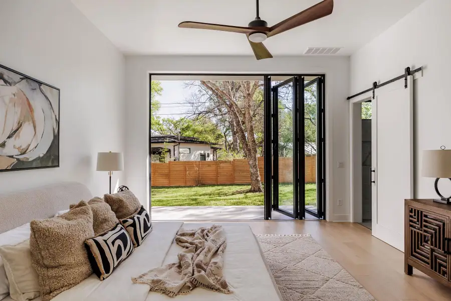 The primary suite showcases scale and simplicity, with wide-plank oak flooring and a calming, neutral palette. The primary suite showcases scale and simplicity, with wide-plank oak flooring and a calming, neutral palette.
