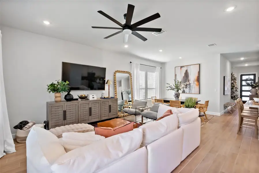Living room featuring wood finish floors, ceiling fan, and recessed lighting