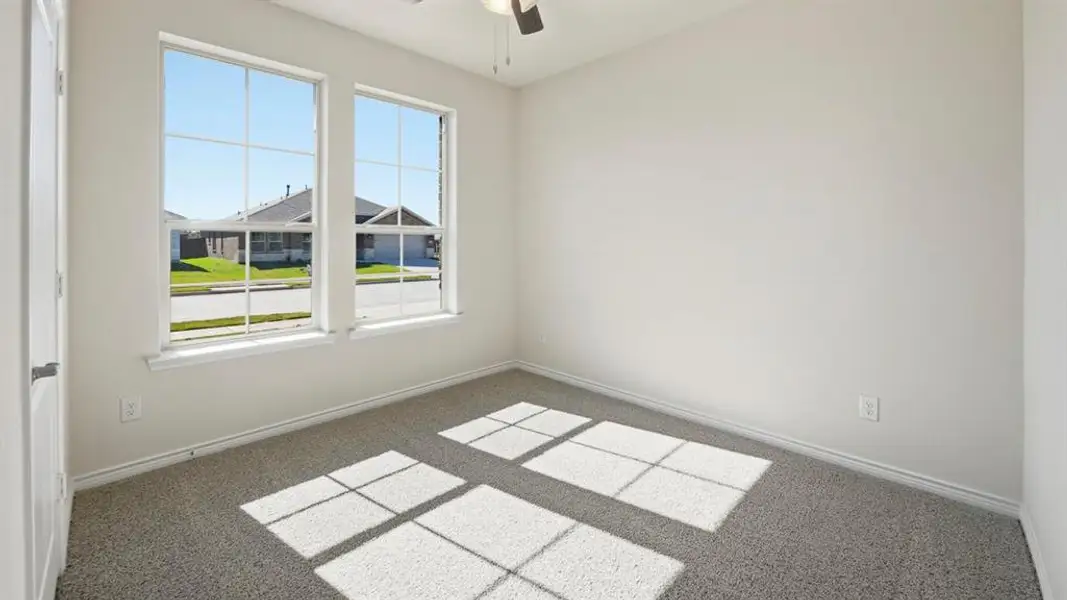 Spare room with carpet flooring and a ceiling fan Spare room with carpet flooring and a ceiling fan