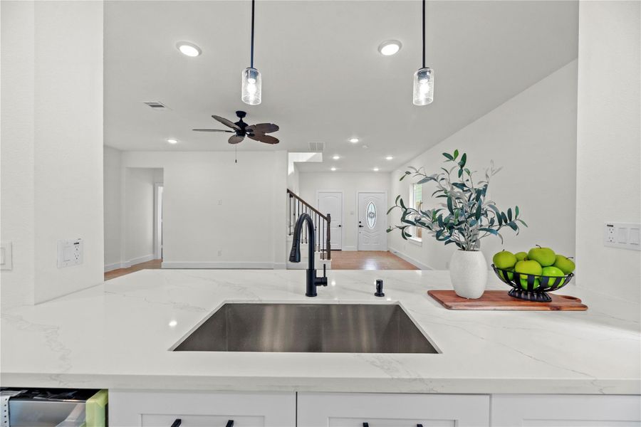 The spacious breakfast bar provides extra counter space, making it perfect for meal prep or serving as a family gathering spot. The spacious breakfast bar provides extra counter space, making it perfect for meal prep or serving as a family gathering spot.