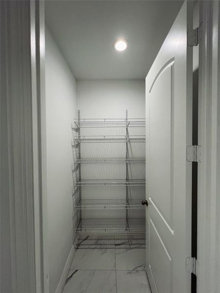 Spacious closet featuring marble finish floor Spacious closet featuring marble finish floor