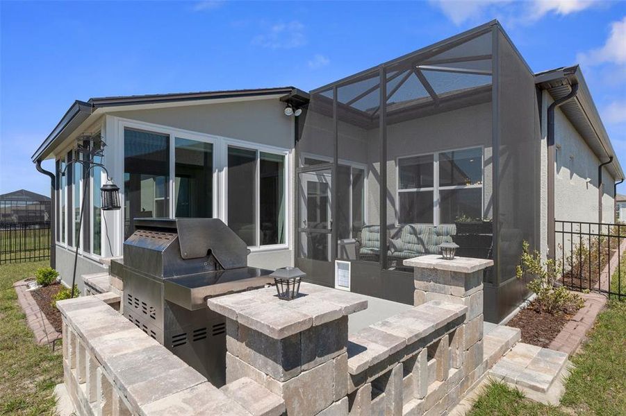 view of grilling patio and screened in lanai