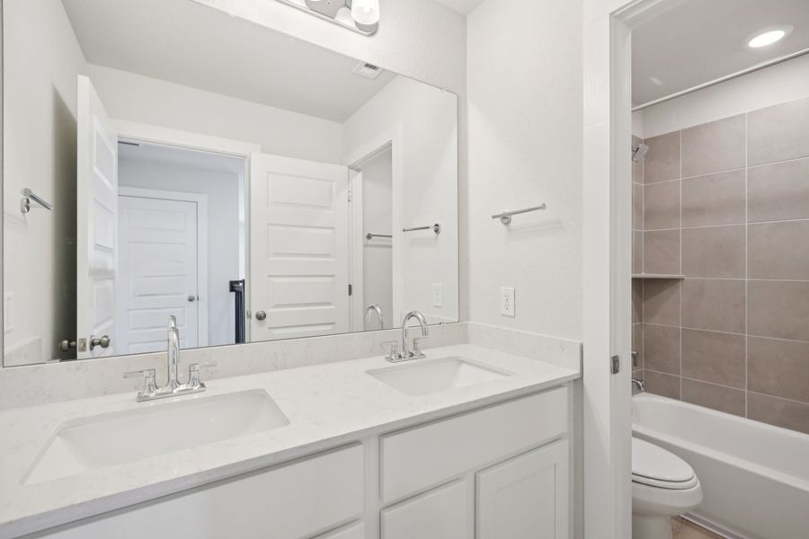 A bathroom with a large mirror.