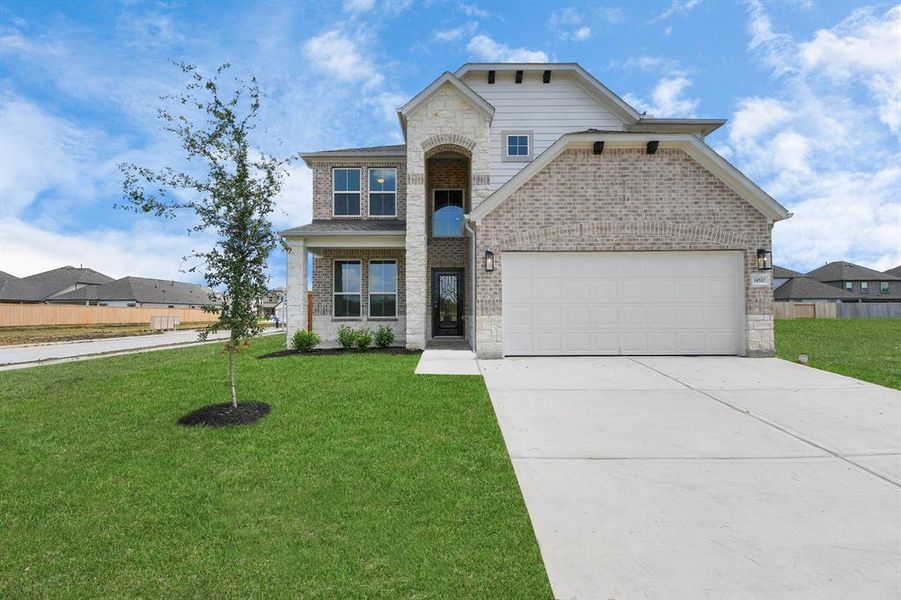 The residence features a practical 2-car garage complemented by a generous driveway, ensuring abundant space for parking needs.