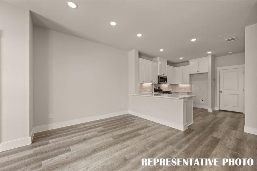 The kitchen peninsula offers a great place for a quick bite or homework station.  REPRESENTATIVE PHOTO