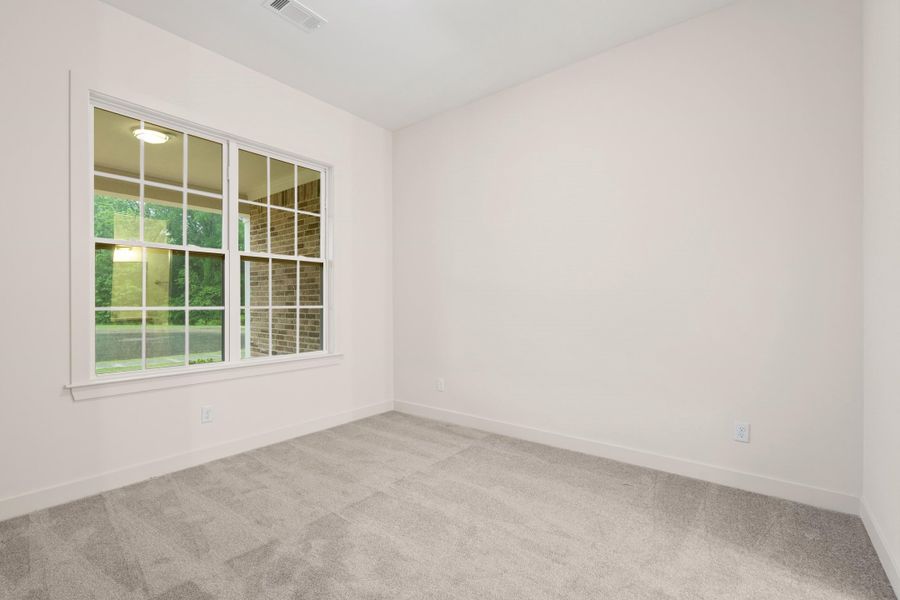 Room with light neutral walls and gray carpet flooring Room with light neutral walls and gray carpet flooring