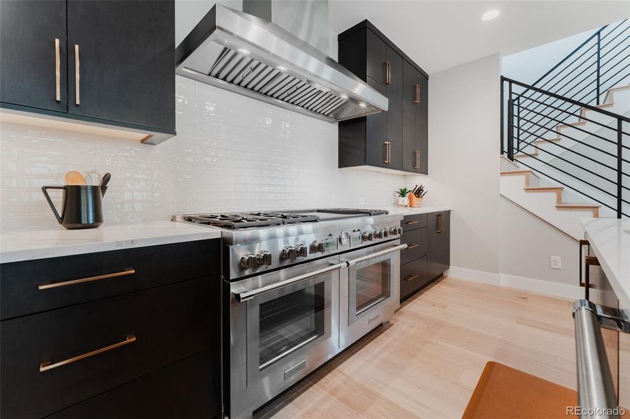 The chef’s kitchen embodies a fusion of illustrious form and function offering the pinnacle of culinary technology with professional grade appliances, including a profound 60” Thermador 8-burner, double griddle dual fuel gas range. WOW factor!!