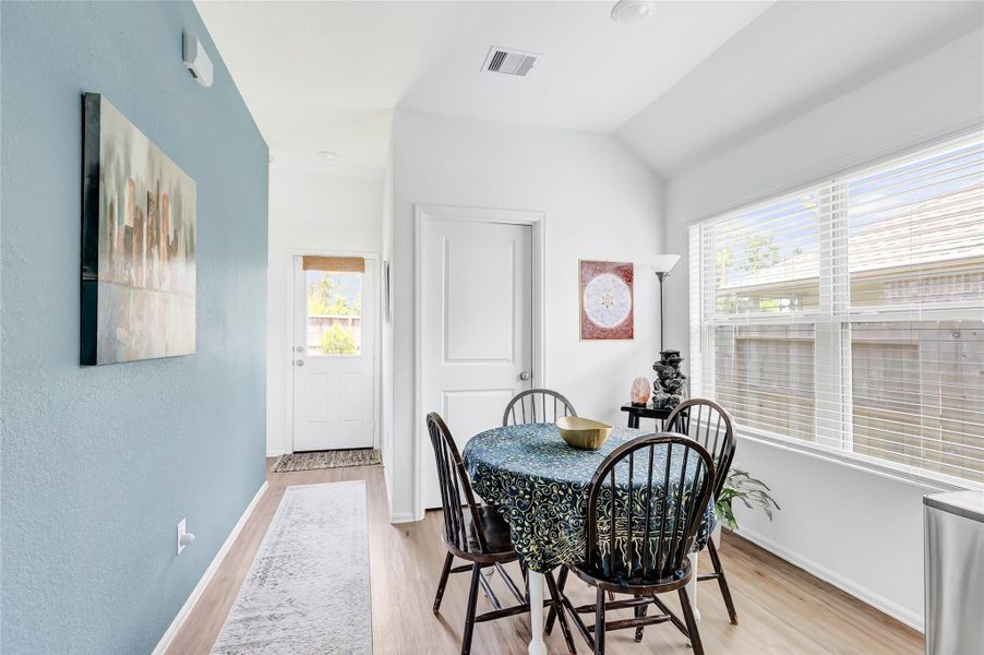 Love the blue accent wall in the kitchen and dining area! That door leads to the utility room - very versatile and functional floor plan.
