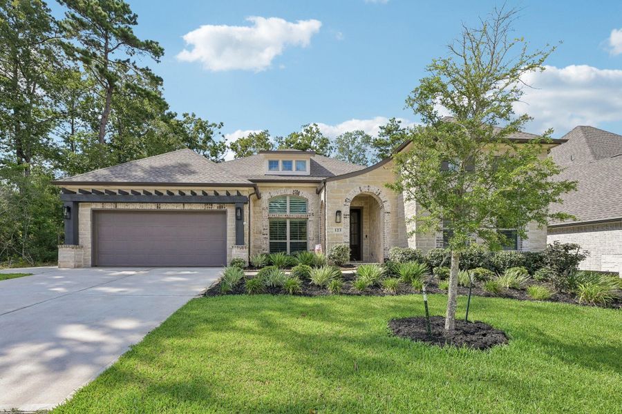 Front exterior of a new home in The Woodlands Hills, Willis, TX, highlighting curb appeal (Image 22).