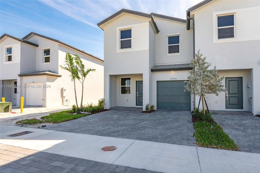 Front exterior of a new home in , Homestead, FL, highlighting curb appeal (Image 25).