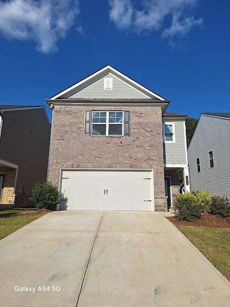 Front exterior of a new home in Westgate Enclave, Loganville, GA, highlighting curb appeal (Image 1).
