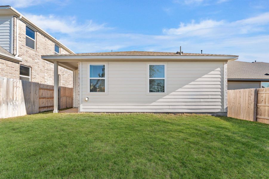 Rear view of house with a fenced backyard Rear view of house with a fenced backyard