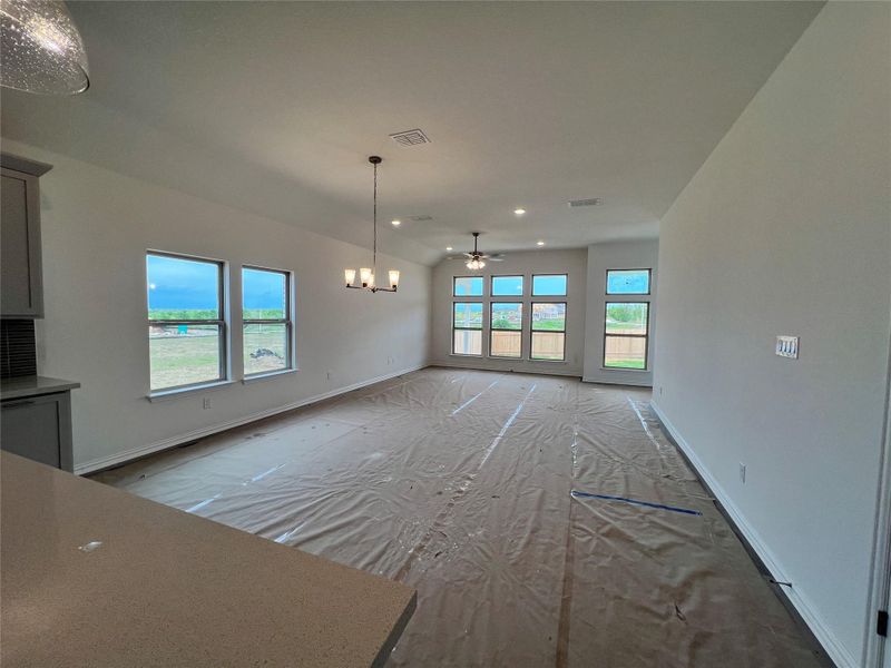 Unfurnished dining area with ceiling fan, a chandelier, and recessed lighting Unfurnished dining area with ceiling fan, a chandelier, and recessed lighting