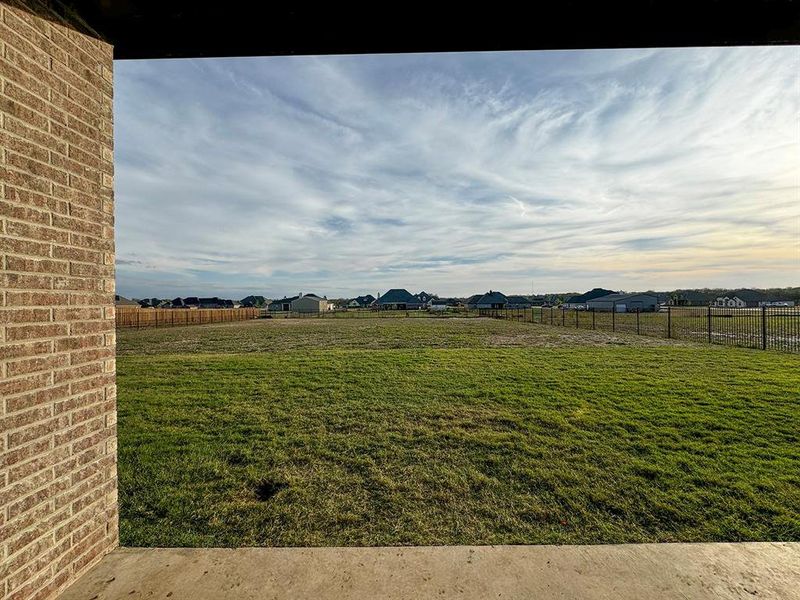 View of large, completely fenced-in back yard