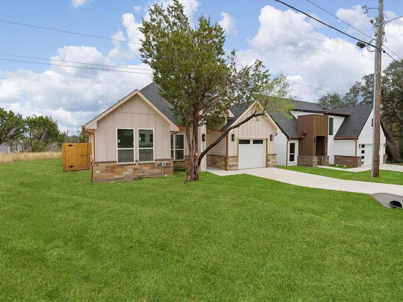 Modern farmhouse style home with a garage and a front lawn